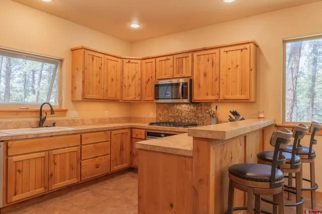 a kitchen with stainless steel appliances granite countertop a sink and cabinets