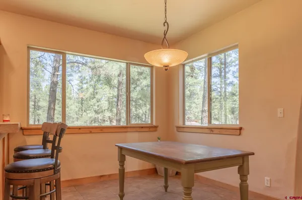 a bathroom with a toilet a sink a window and shower