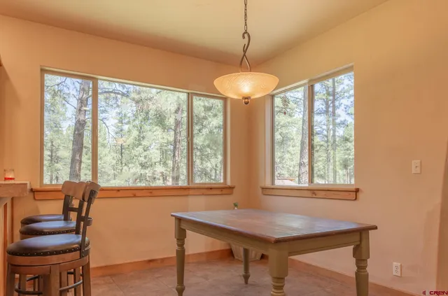 a view of a dining room with furniture window and outside view