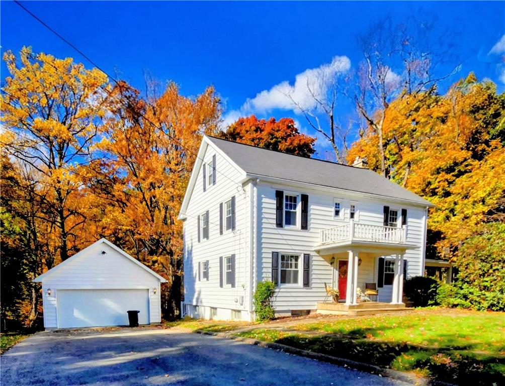 a front view of a house with swimming pool and sitting area