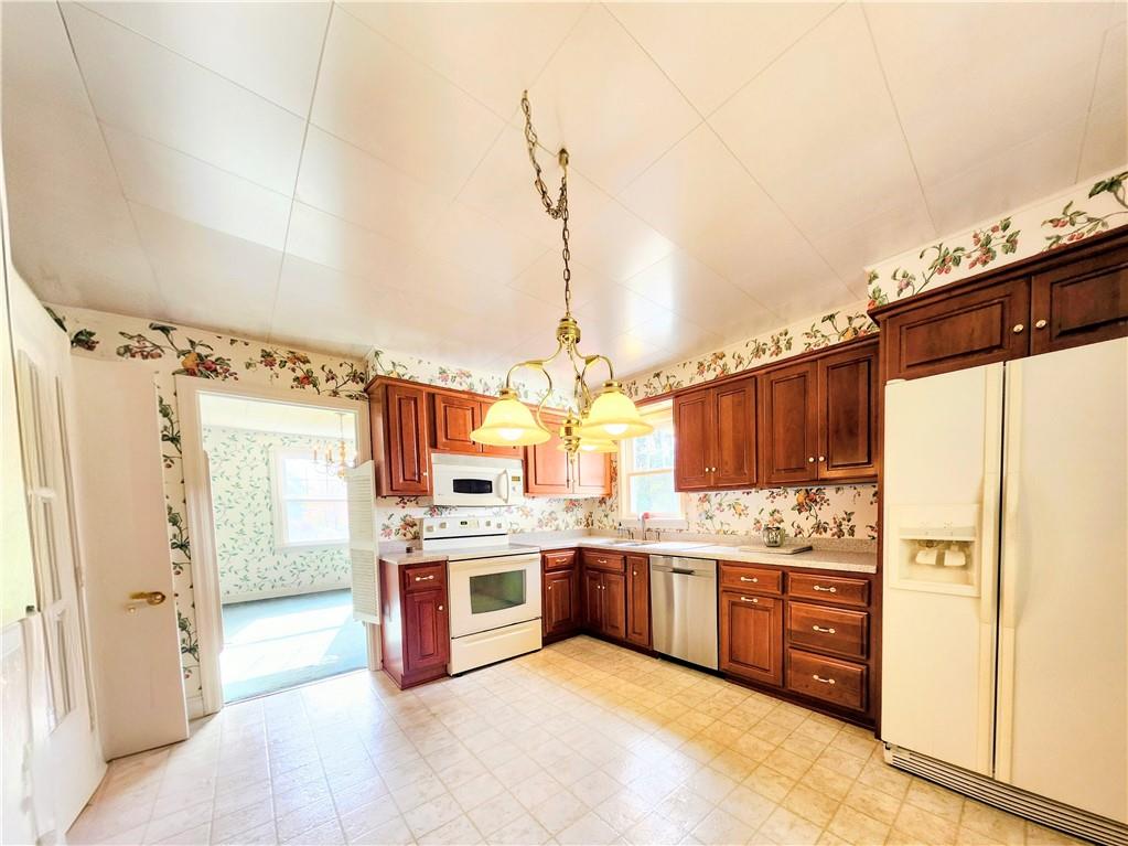 499 White School Road Greensburg, PA 15601 - Photo 4 of 38 a kitchen with stainless steel appliances granite countertop a stove a refrigerator and a stove