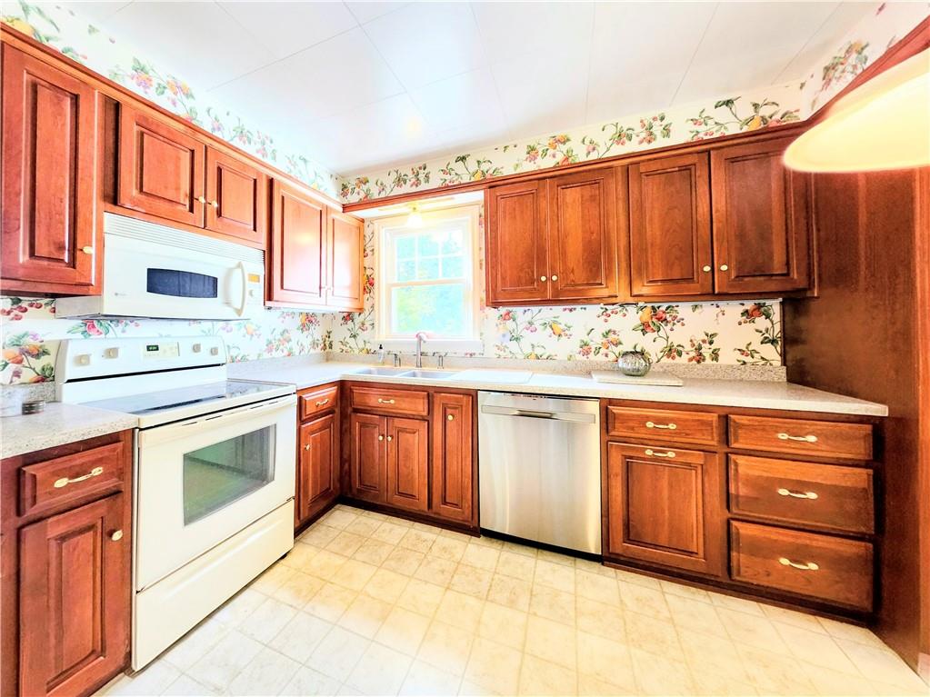 499 White School Road Greensburg, PA 15601 - Photo 5 of 38 a kitchen with stainless steel appliances granite countertop a sink window and cabinets
