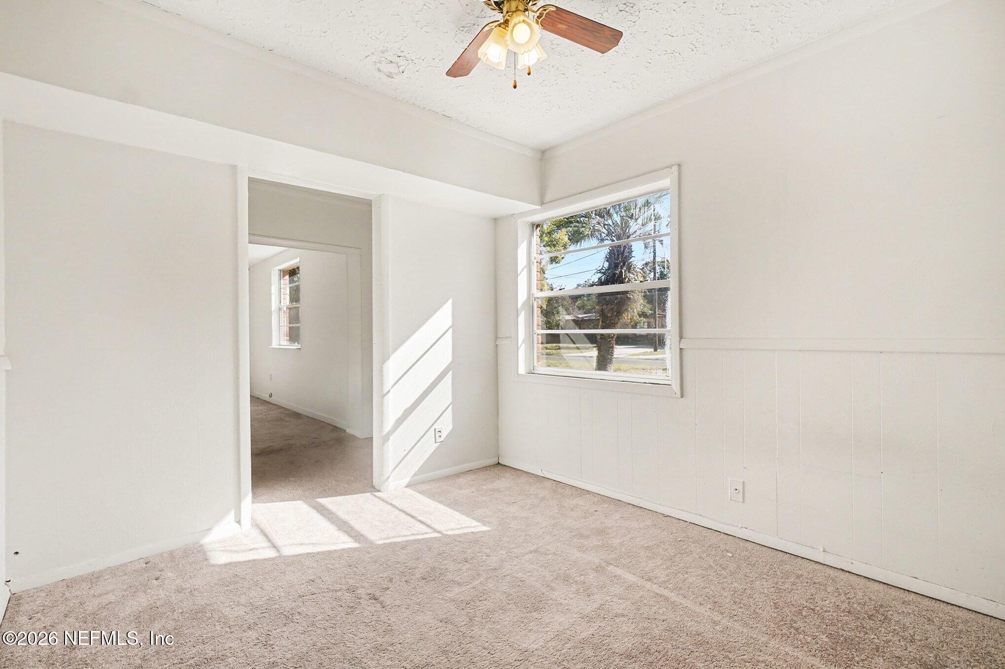 3661 Calla Drive Jacksonville, FL 32207 - Photo 8 of 16 an empty room with windows and ceiling fan