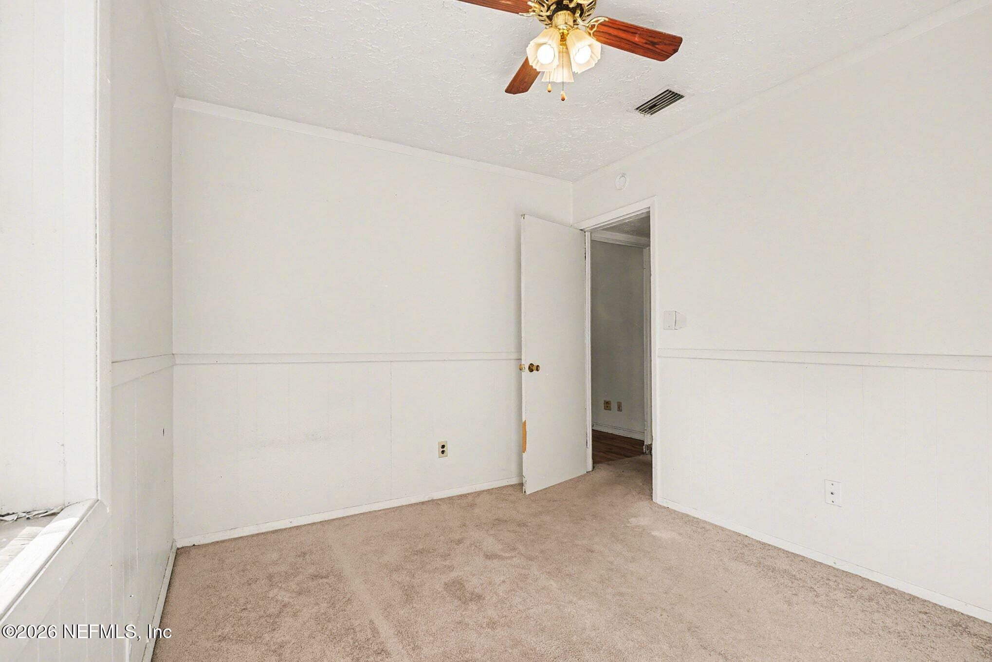 3661 Calla Drive Jacksonville, FL 32207 - Photo 10 of 16 an empty room with a chandelier fan