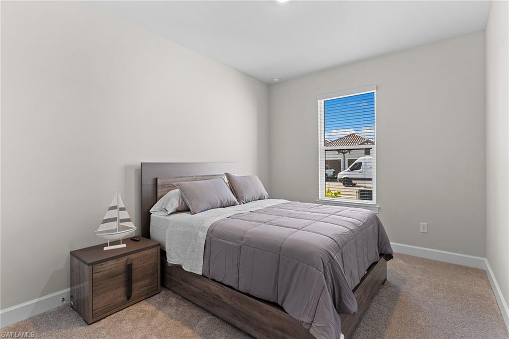 15657 Gavello Street Naples, FL 34114 - Photo 14 of 37 a bedroom with a bed and a window