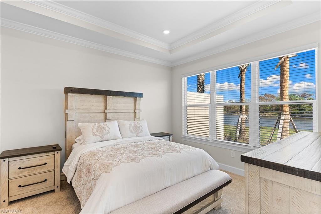 15657 Gavello Street Naples, FL 34114 - Photo 17 of 37 a bedroom with a large bed and a large window