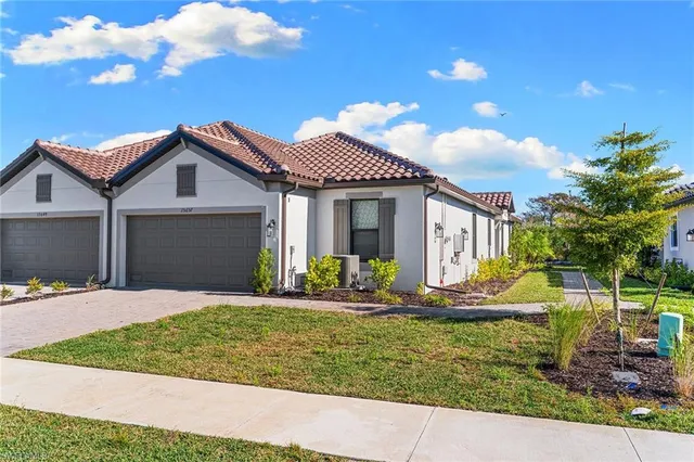 a front view of a house with a yard and garage