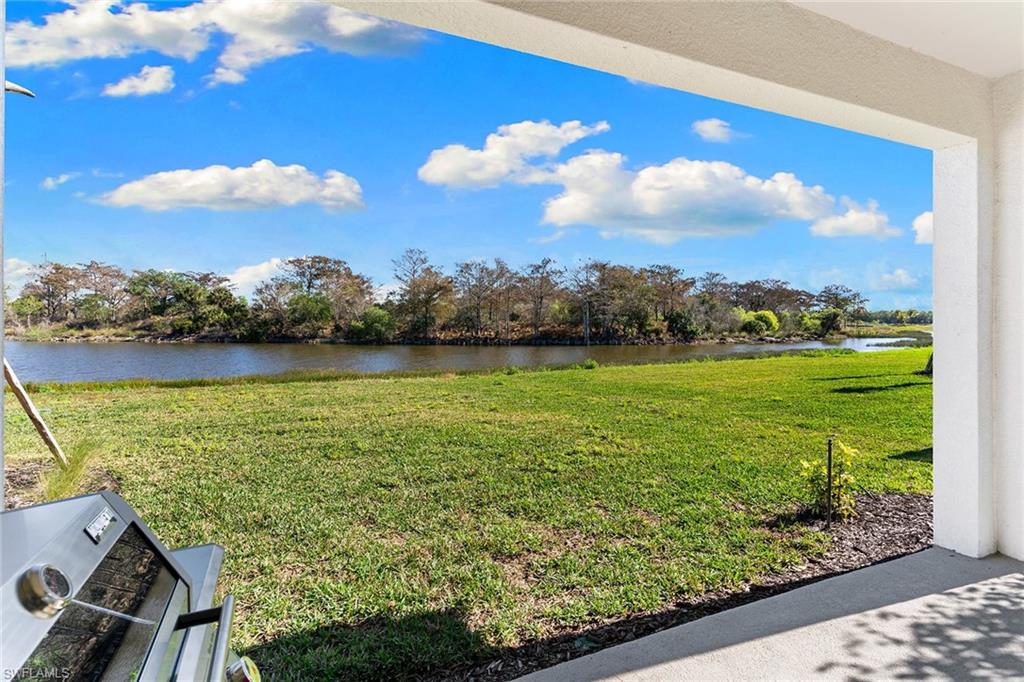 15657 Gavello Street Naples, FL 34114 - Photo 25 of 37 a view of a lake with a yard