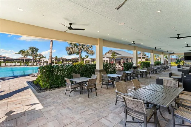 a view of a patio with dining table and chairs