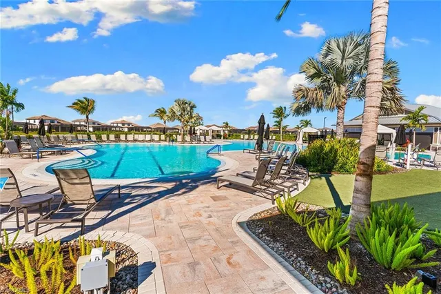 a view of swimming pool with outdoor seating and plants