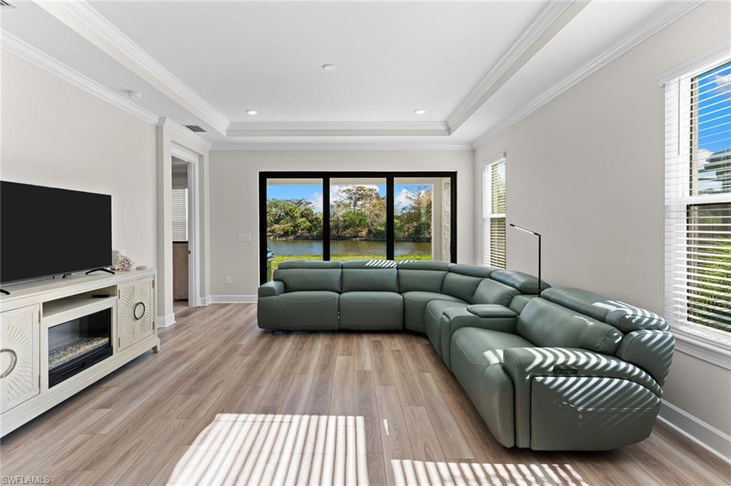 15657 Gavello Street Naples, FL 34114 - Photo 4 of 37 a living room with furniture and a flat screen tv