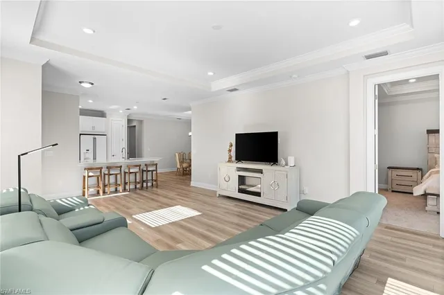 a bedroom with furniture and a flat screen tv