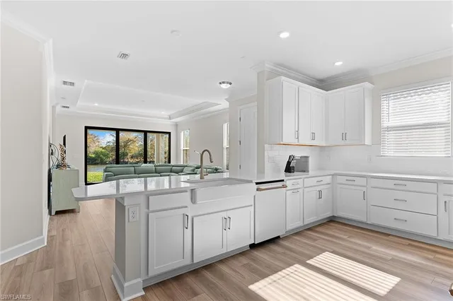 a kitchen with sink cabinets and wooden floor
