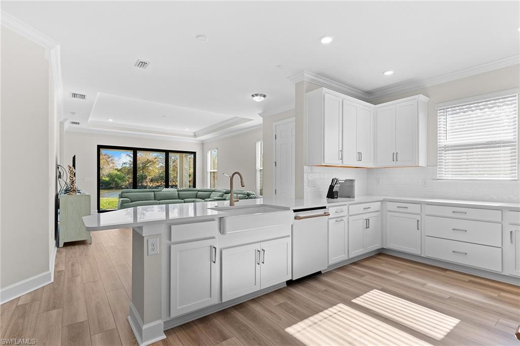 15657 Gavello Street Naples, FL 34114 - Photo 8 of 37 a kitchen with sink cabinets and wooden floor