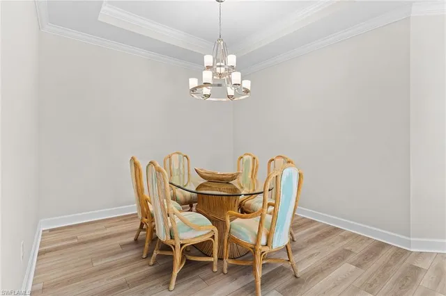 a view of a dining room with furniture and chandelier