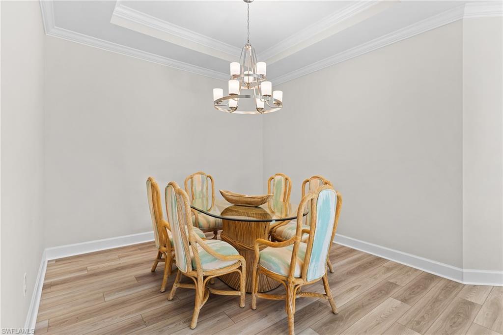15657 Gavello Street Naples, FL 34114 - Photo 9 of 37 a view of a dining room with furniture and chandelier