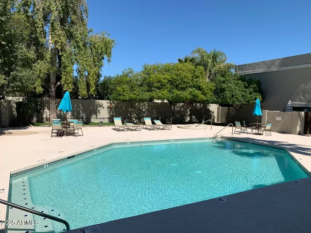 a view of a swimming pool with a patio