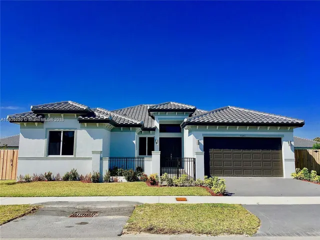 a front view of a house with garage