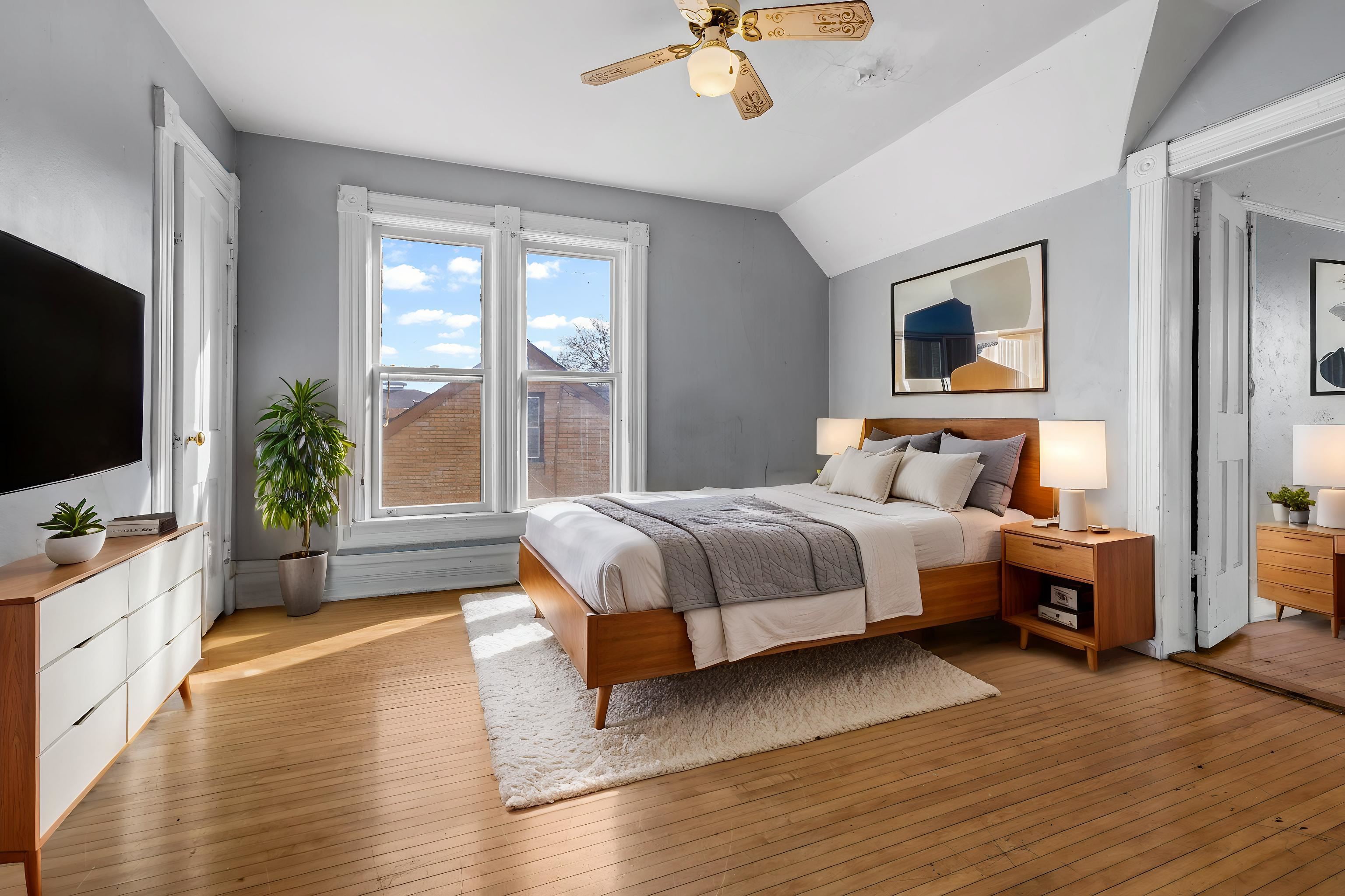 219 Rome Avenue Rockford, IL 61107 - Photo 20 of 24 a bedroom with a bed and a flat screen tv