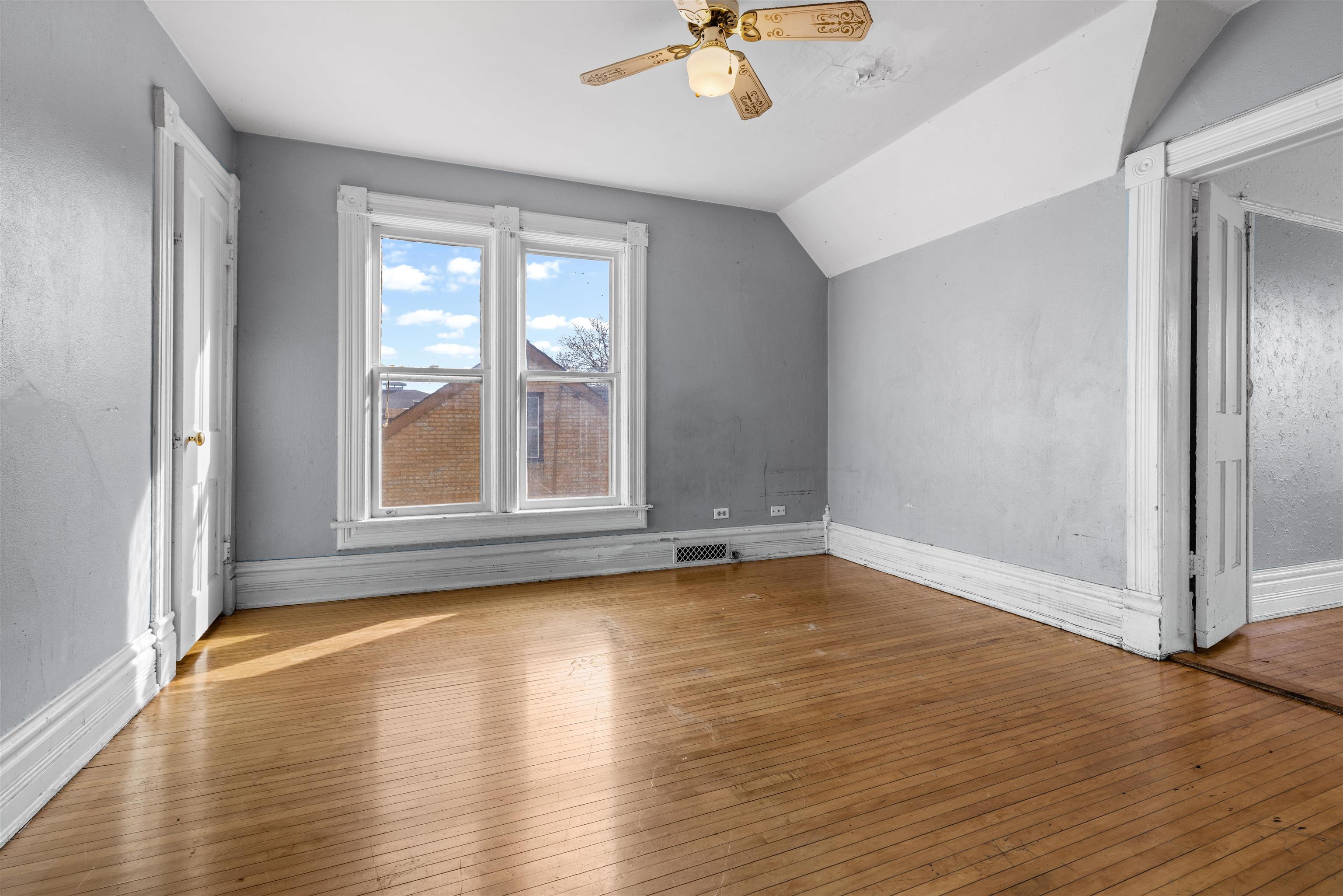 219 Rome Avenue Rockford, IL 61107 - Photo 21 of 24 a view of empty room with wooden floor and fan