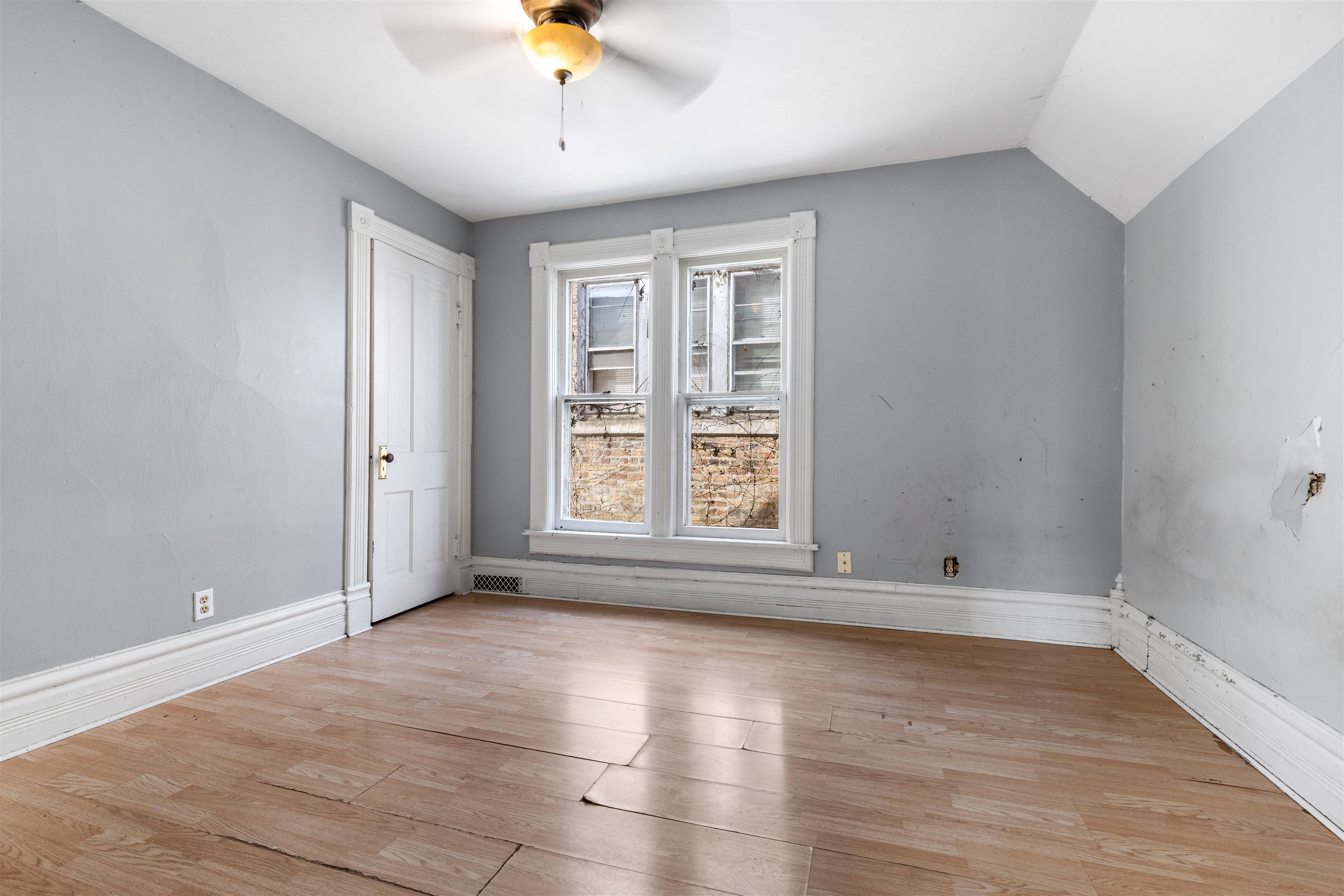 219 Rome Avenue Rockford, IL 61107 - Photo 23 of 24 wooden floor in an empty room with a window