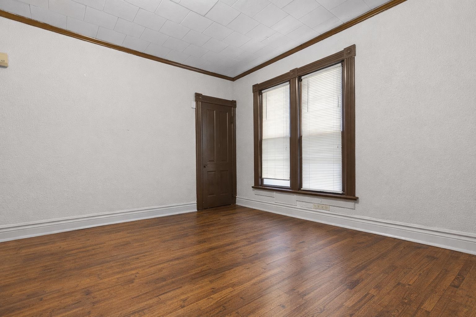 219 Rome Avenue Rockford, IL 61107 - Photo 8 of 24 a view of an empty room with wooden floor and a window