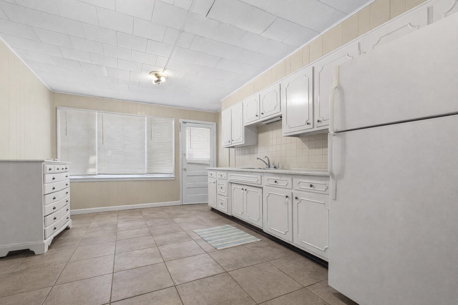 219 Rome Avenue Rockford, IL 61107 - Photo 9 of 24 a kitchen with granite countertop white cabinets and white appliances