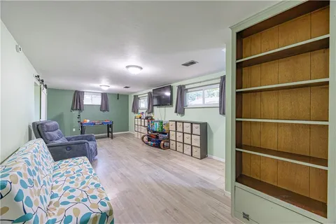 a living room with furniture window and wooden floor