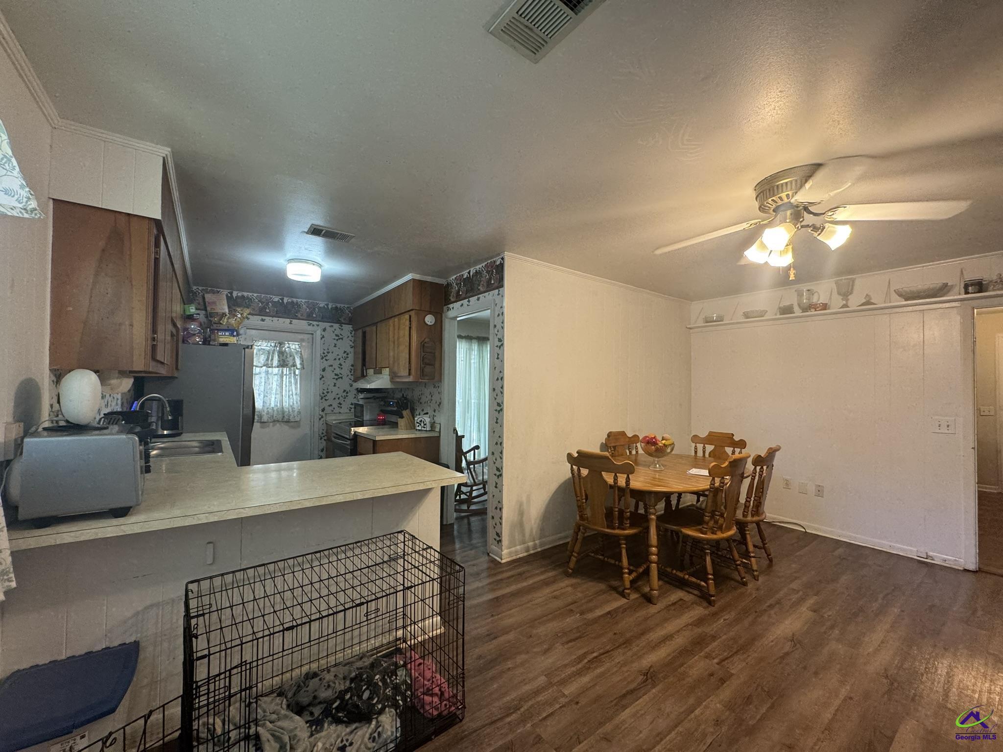 1032 Elberta Road Warner Robins, GA 31093 - Photo 6 of 26 a view of a dining room with furniture and wooden floor