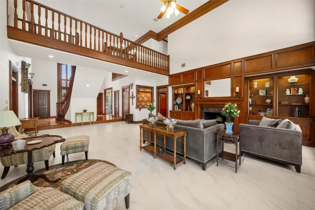 a living room with furniture a fireplace and a large window