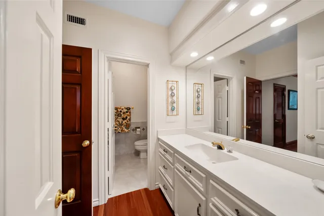 a en suite bathroom with a double vanity sink a mirror and shower