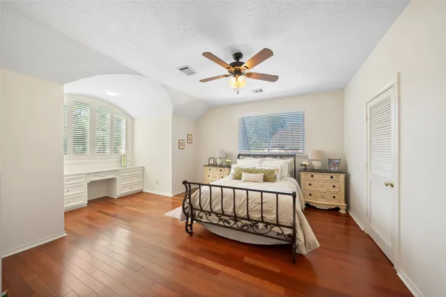 a bedroom with a bed and a chandelier