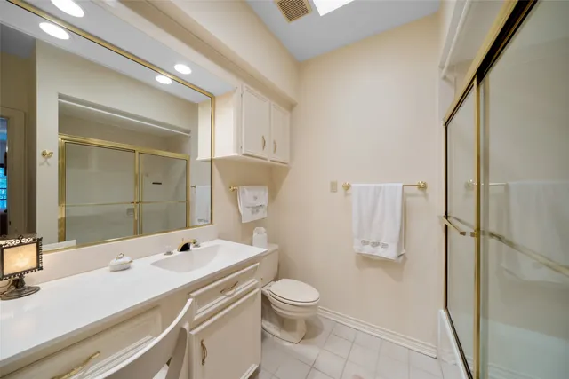 a bathroom with a sink toilet a mirror and shower