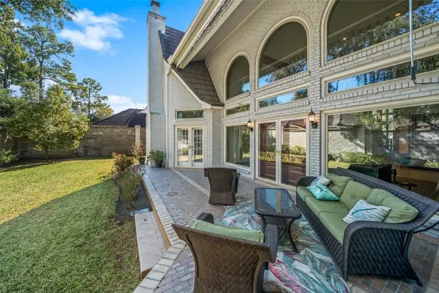 a view of a patio with couches table and chairs and potted plants