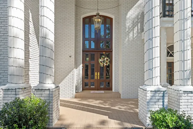 a front view of a building with a tree
