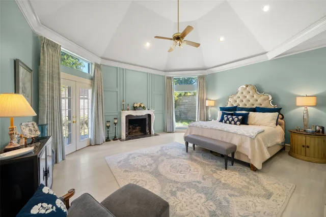 a spacious bedroom with a bed and a chandelier