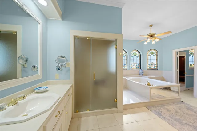 a spacious bathroom with a tub shower and sink
