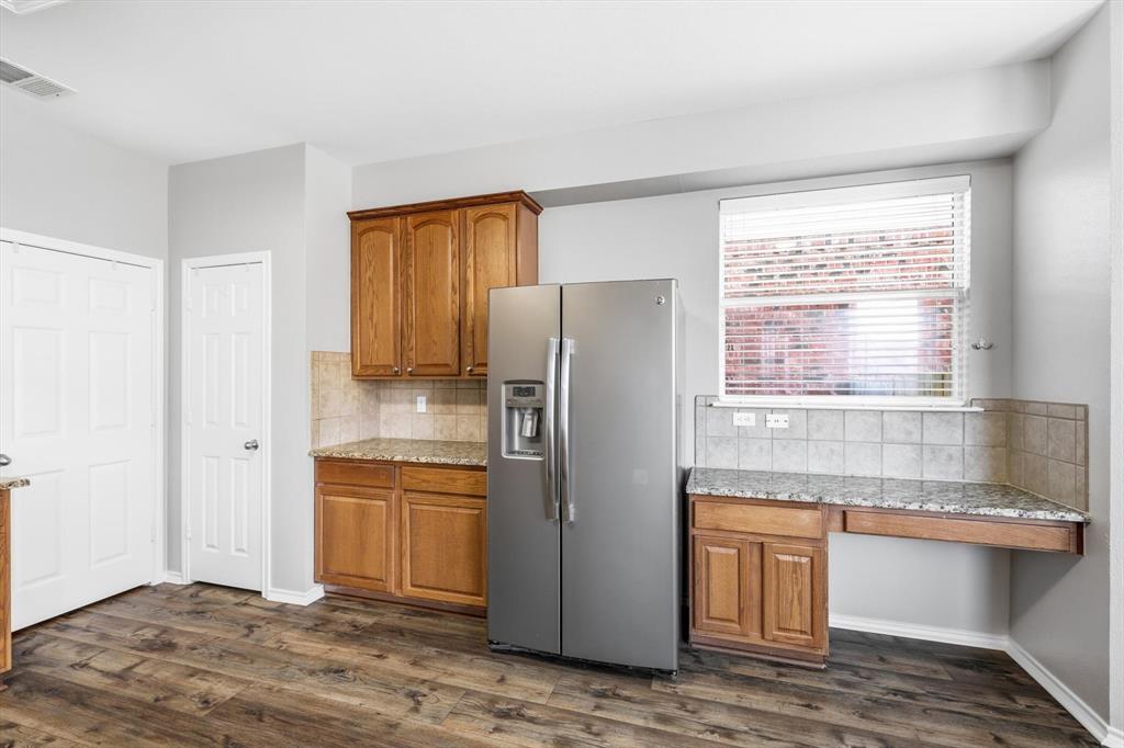 5229 Westheimer Road Fort Worth, TX 76244 - Photo 14 of 39 a kitchen with granite countertop a refrigerator and a sink