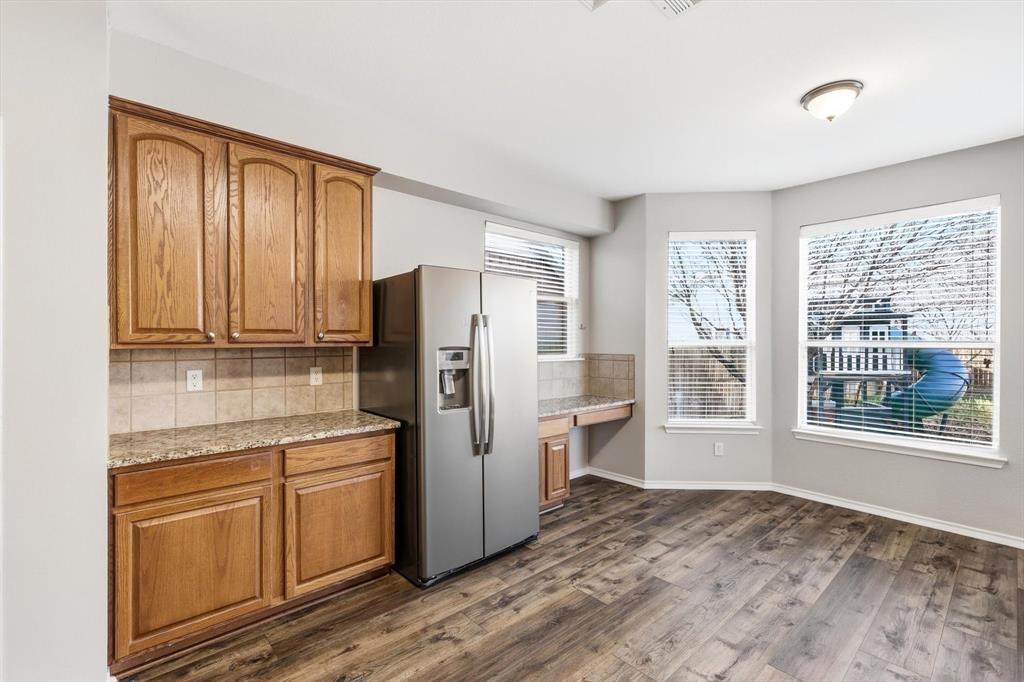 5229 Westheimer Road Fort Worth, TX 76244 - Photo 15 of 39 a kitchen with stainless steel appliances a refrigerator sink and cabinets