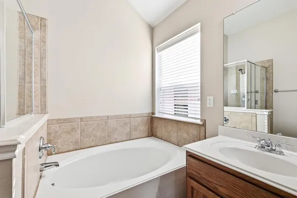 a bathroom with a sink a mirror and a shower