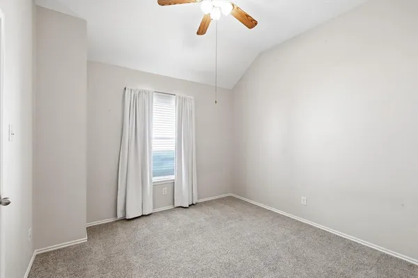 a view of an empty room with a ceiling fan