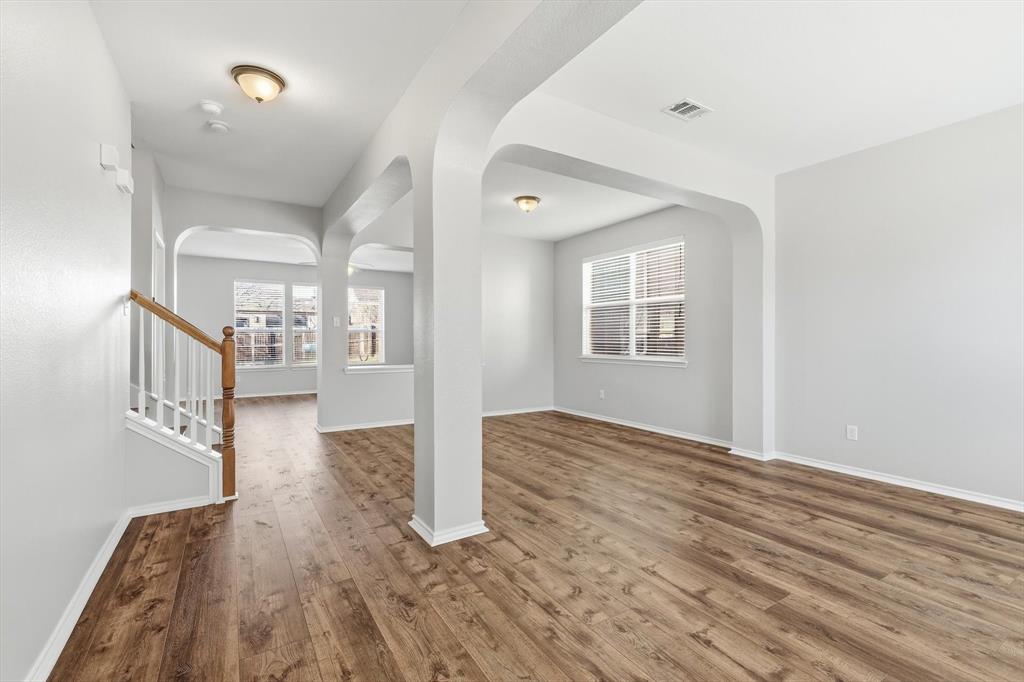 5229 Westheimer Road Fort Worth, TX 76244 - Photo 9 of 39 a view of an empty room with wooden floor and a window