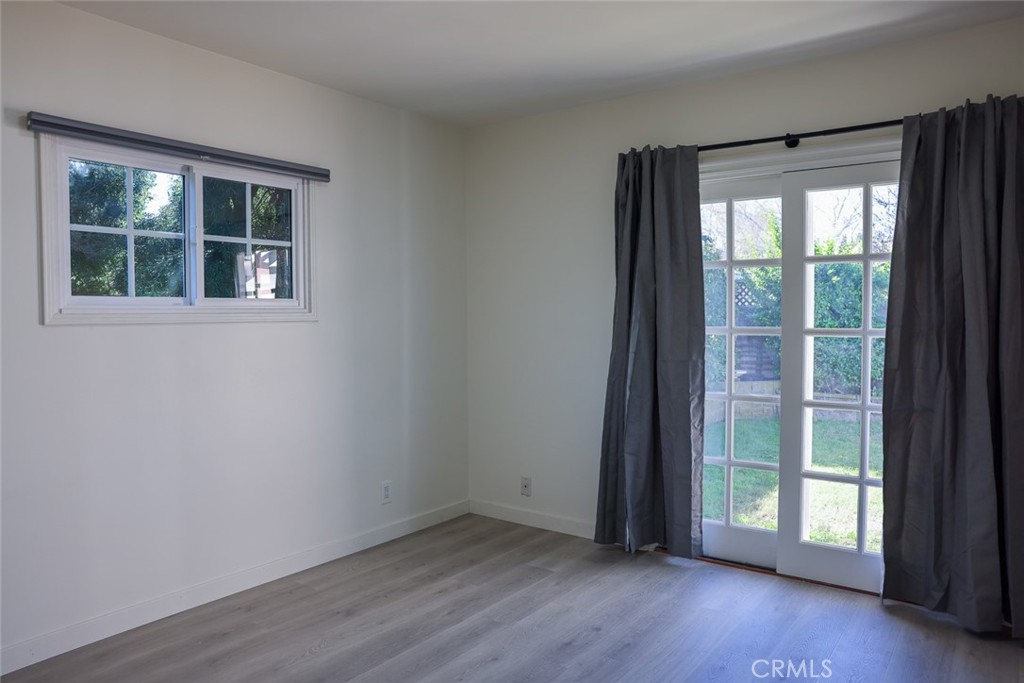11253 Segrell Way Culver City, CA 90230 - Photo 11 of 17 an empty room with wooden floor and windows