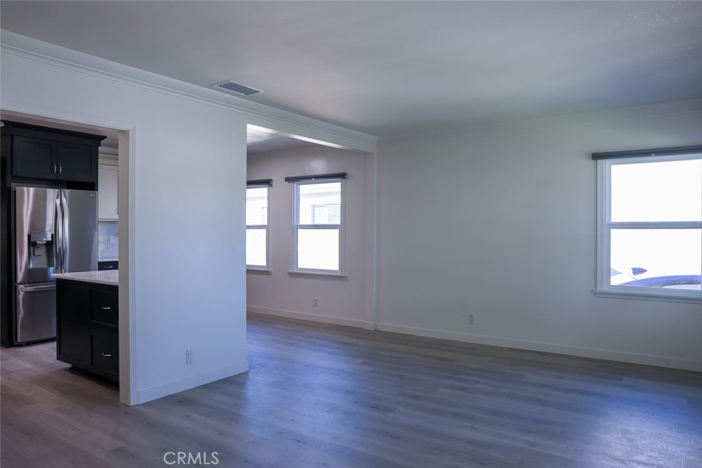 11253 Segrell Way Culver City, CA 90230 - Photo 3 of 17 an empty room with wooden floor and windows