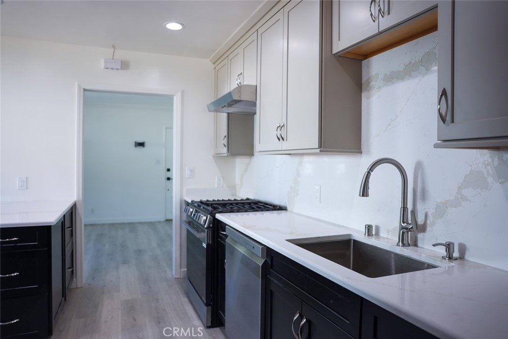 11253 Segrell Way Culver City, CA 90230 - Photo 4 of 17 a kitchen with a sink cabinets and stainless steel appliances