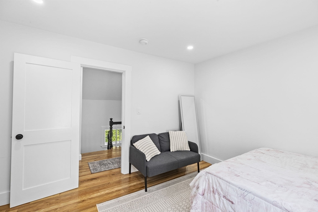 81 Ocean View Road Swampscott, MA 01907 - Photo 28 of 38 a bedroom with a bed and a couch