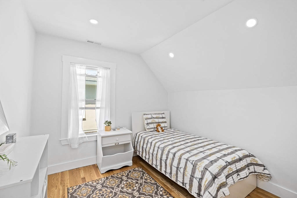 81 Ocean View Road Swampscott, MA 01907 - Photo 29 of 38 a bedroom with a bed and a table in it