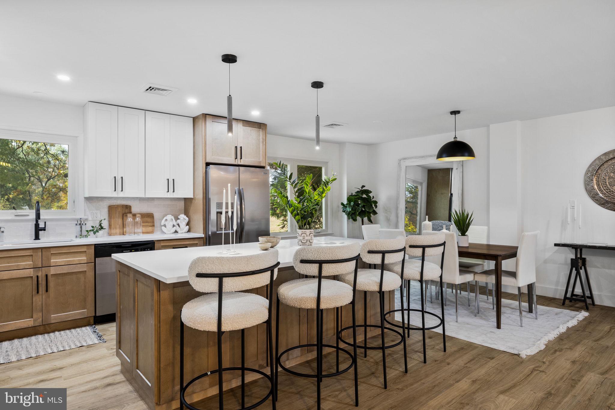1189 Foxview Road Pottstown, PA 19465 - Photo 15 of 58 a kitchen with stainless steel appliances kitchen island granite countertop a dining table chairs and white cabinets