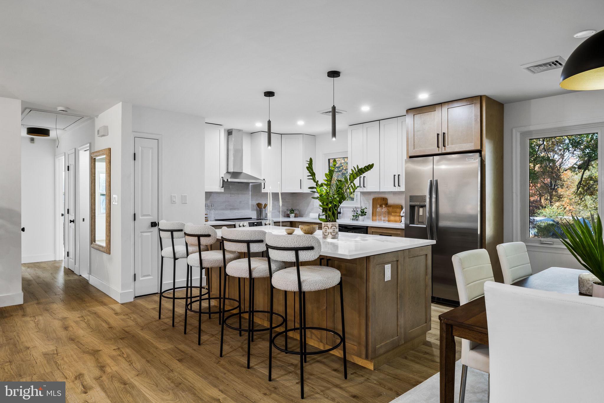 1189 Foxview Road Pottstown, PA 19465 - Photo 18 of 58 a kitchen with a dining table chairs refrigerator and cabinets
