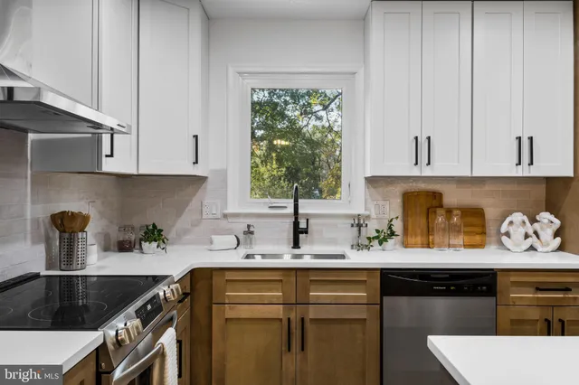 a bathroom with a granite countertop sink a toilet and mirror